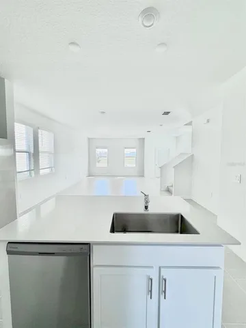 a kitchen with stainless steel appliances a sink a refrigerator and a stove