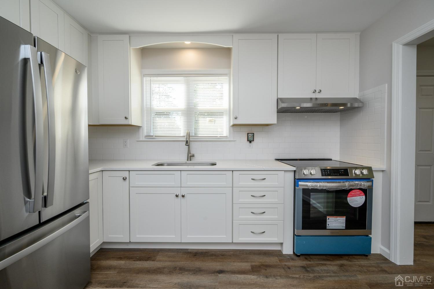 16 Green Road Mine Hill, NJ 07803 - Photo 11 of 53 a kitchen with stainless steel appliances white cabinets and a refrigerator