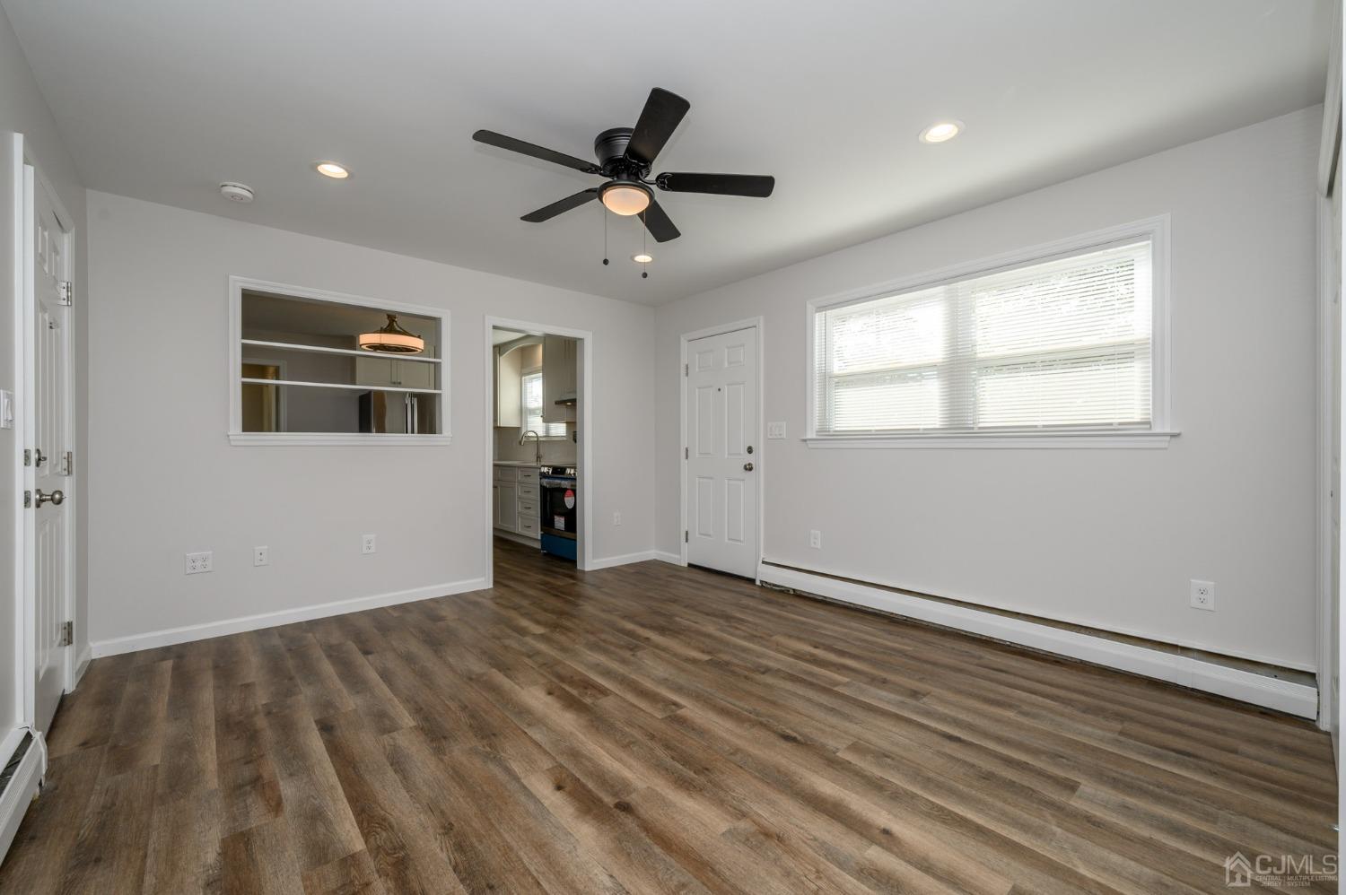 16 Green Road Mine Hill, NJ 07803 - Photo 16 of 53 an empty room with wooden floor ceiling fan and windows