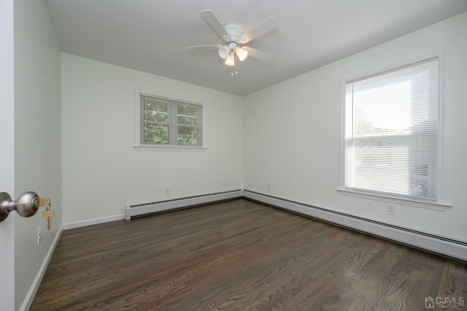 16 Green Road Mine Hill, NJ 07803 - Photo 23 of 53 an empty room with wooden floor and windows