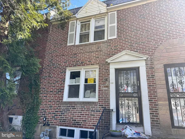 a view of a brick house with many windows