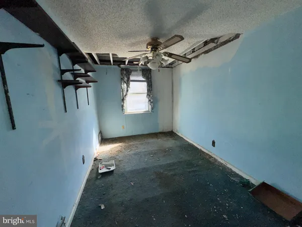 a view of a hallway with paintings on the wall