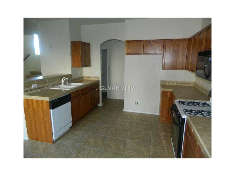 205 Heiple Court Henderson, NV 89052 - Photo 6 of 35 Kitchen. OPEN KITCHEN WITH TILED FLOOR AND COUNTER TOPS
