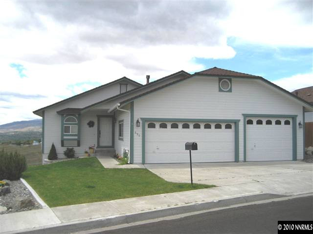 690 Tarn Way Reno, NV 89503 - Photo 2 of 13 a front view of a house with a yard and garage