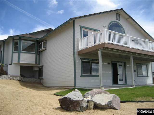 690 Tarn Way Reno, NV 89503 - Photo 4 of 13 a front view of a house with a yard