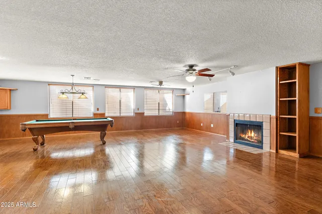a view of an empty room with a fireplace and a window