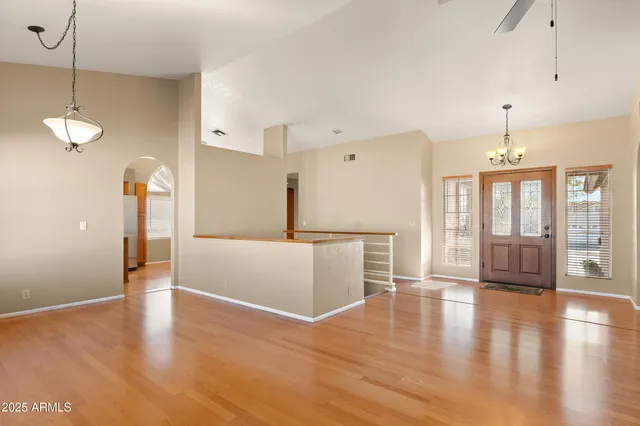 a front view of a house with a yard and potted plants