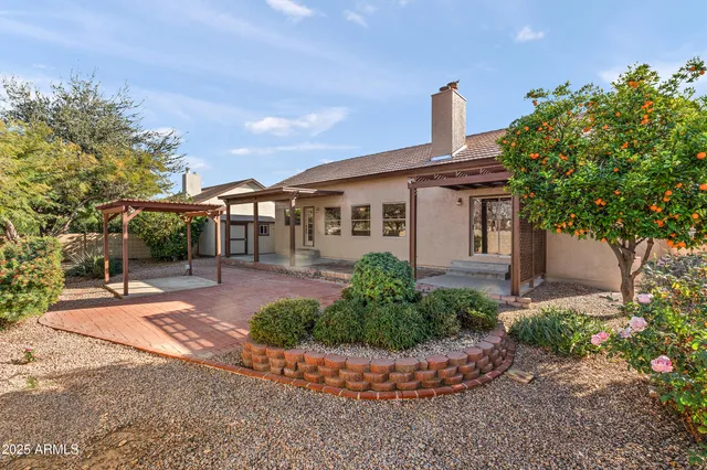 a bathroom with a granite countertop double vanity sink a mirror and bathtub