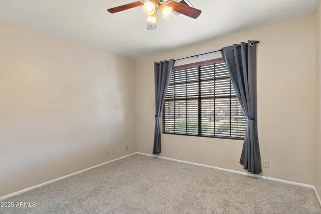 a bathroom with a granite countertop sink toilet and mirror