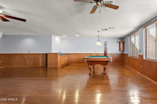 a view of a room with a ceiling fan and a fan