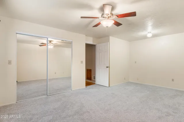 a bathroom with a granite countertop sink a toilet a mirror and shower