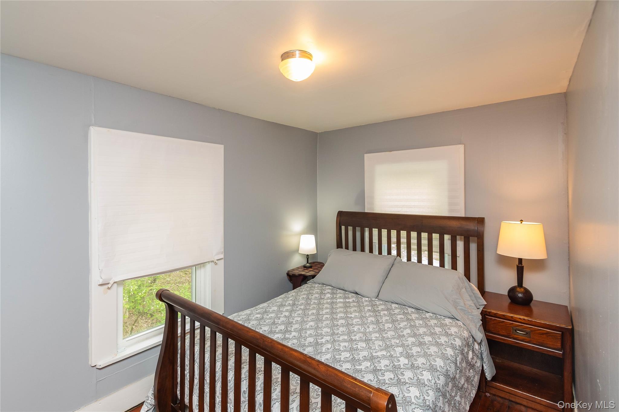 189 Church Street Hancock, NY 13783 - Photo 18 of 47 a bedroom with a bed and a lamp with window