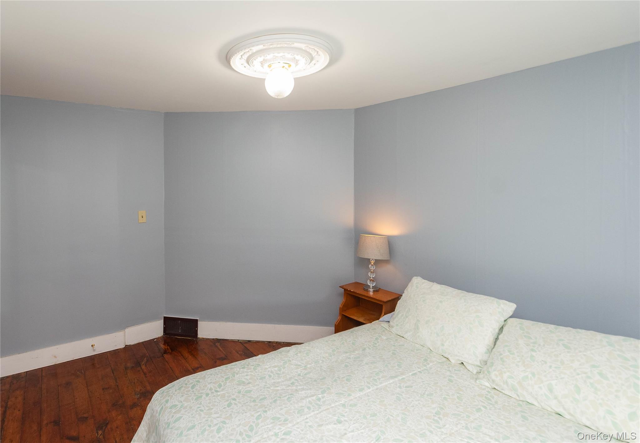 189 Church Street Hancock, NY 13783 - Photo 29 of 47 a bedroom with a bed and a lamp