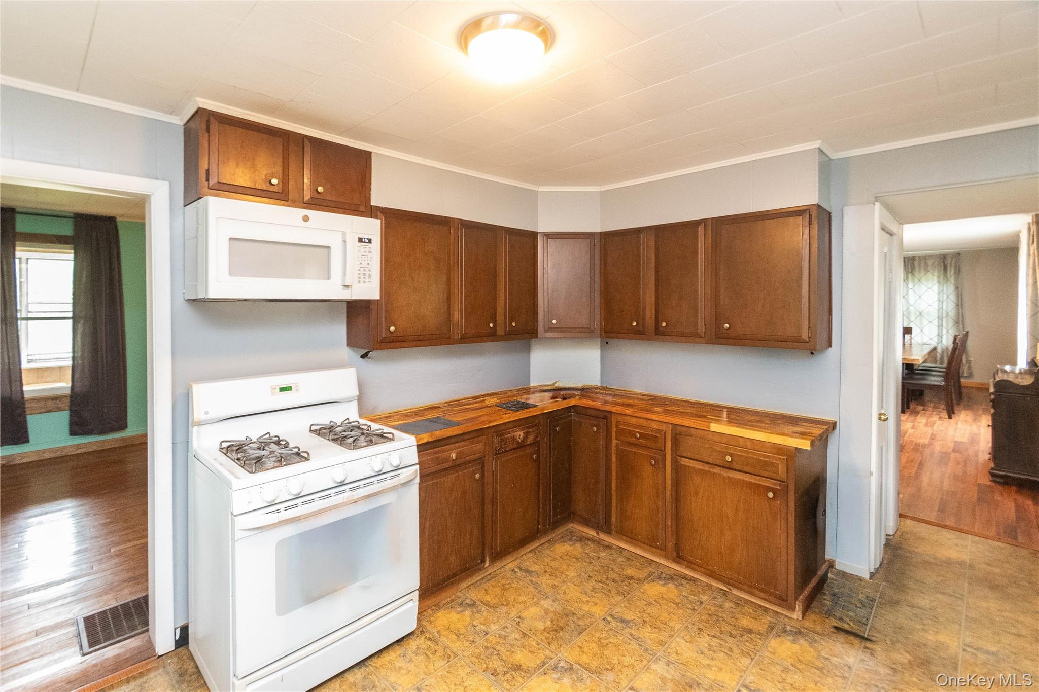 189 Church Street Hancock, NY 13783 - Photo 47 of 47 a kitchen with stainless steel appliances granite countertop a stove a sink and a microwave