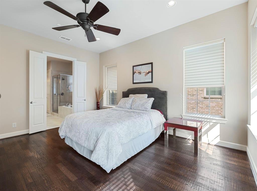 5001 Meridian Lane, Unit 2103 Addison, TX 75001 - Photo 16 of 26 Bedroom featuring rich wood-finish flooring and a ceiling fan with dark blades