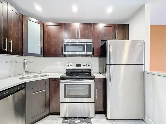 a kitchen with a sink stove and refrigerator