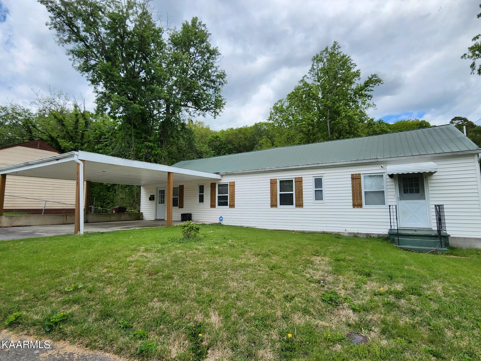 117 Jarrett Lane Oak Ridge, TN 37830 - Photo 2 of 35 a house that has a big yard with wooden fence