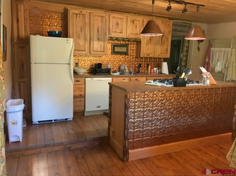 Tbd Shaw Creek Ranch Road Del Norte, CO 81132 - Photo 11 of 35 a kitchen with refrigerator and cabinets