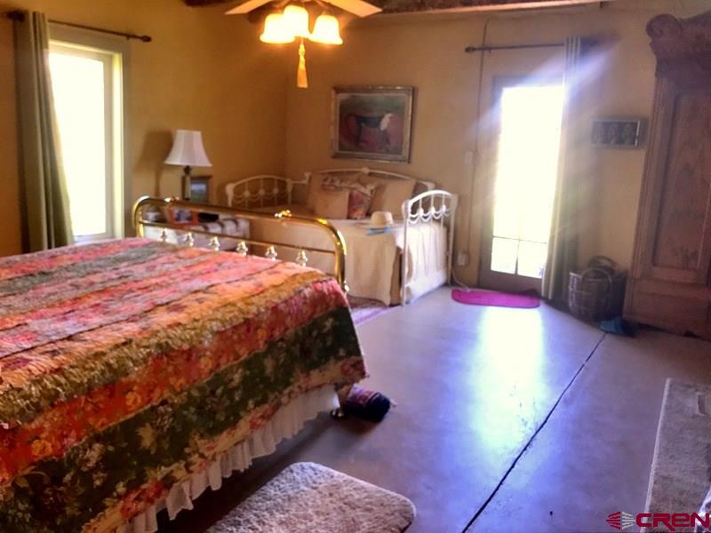 Tbd Shaw Creek Ranch Road Del Norte, CO 81132 - Photo 15 of 35 a bedroom with a bed and a lamp