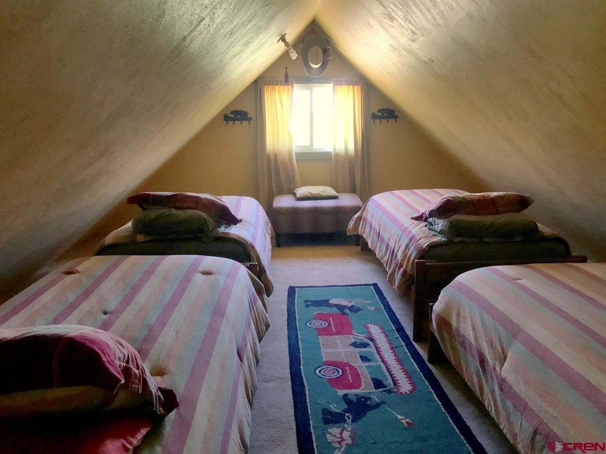 Tbd Shaw Creek Ranch Road Del Norte, CO 81132 - Photo 19 of 35 a bedroom with two beds and a painting on the wall