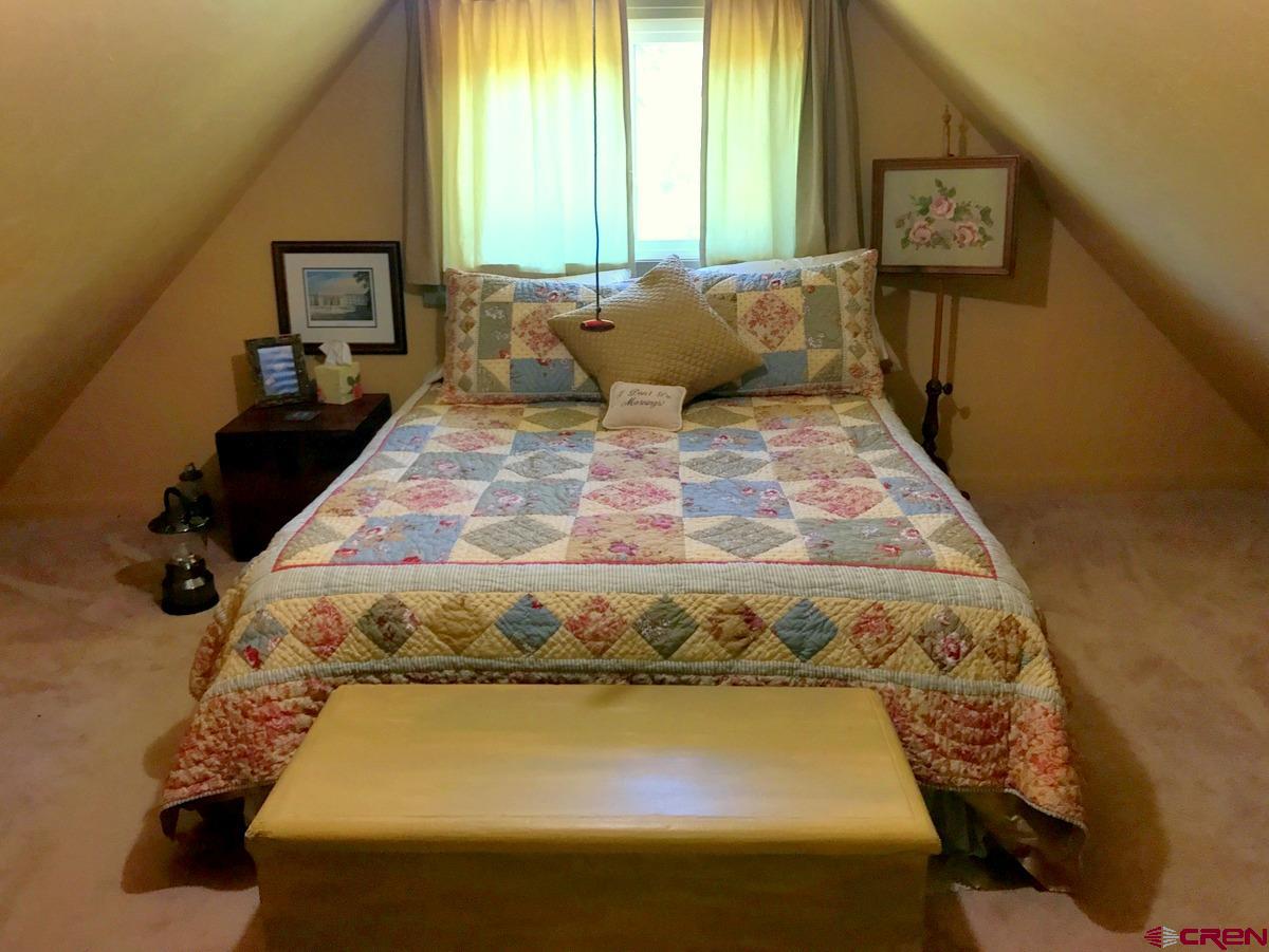 Tbd Shaw Creek Ranch Road Del Norte, CO 81132 - Photo 20 of 35 a bedroom with a bed and wooden floor