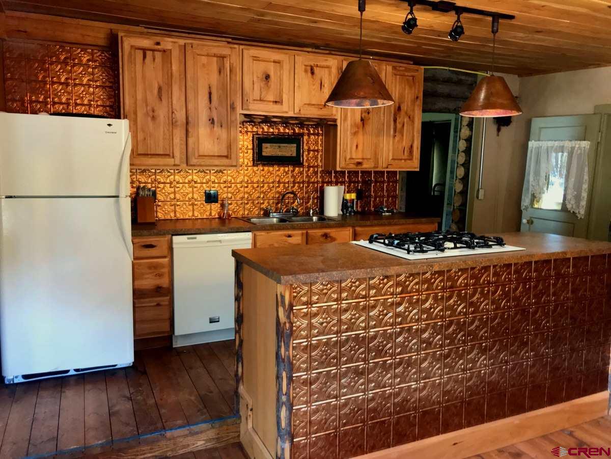 Tbd Shaw Creek Ranch Road Del Norte, CO 81132 - Photo 8 of 35 a kitchen with stainless steel appliances granite countertop a refrigerator and a stove