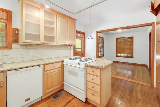 a kitchen with stainless steel appliances granite countertop a stove and a sink
