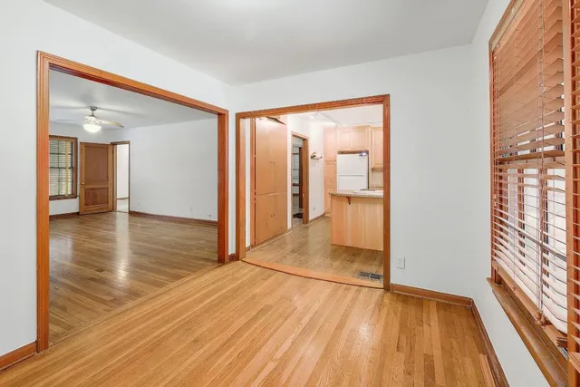 a view of a room with wooden floor and a bathroom