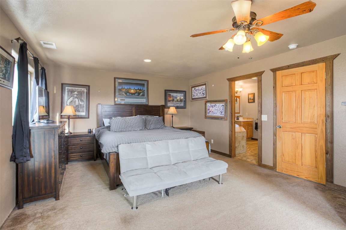 73 Mid Land Avenue Hartsel, CO 80449 - Photo 11 of 31 a spacious bedroom with a bed and a chandelier