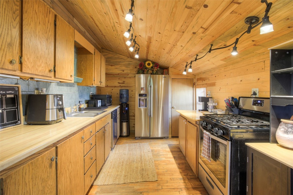 73 Mid Land Avenue Hartsel, CO 80449 - Photo 8 of 31 a kitchen with stainless steel appliances granite countertop a stove a sink and a refrigerator