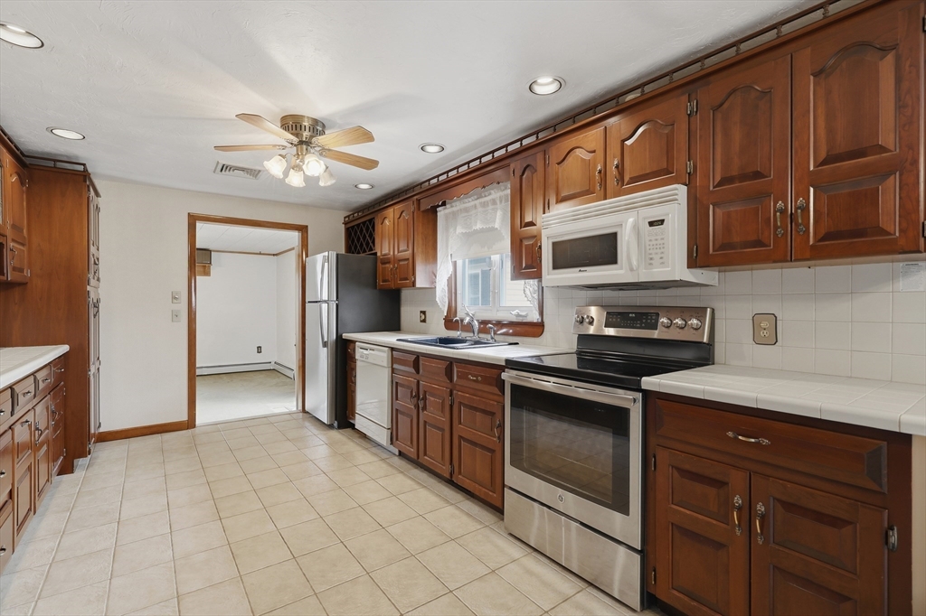 10 Deluca Road Milford, MA 01757 - Photo 12 of 37 a kitchen with stainless steel appliances granite countertop a refrigerator and a stove top oven