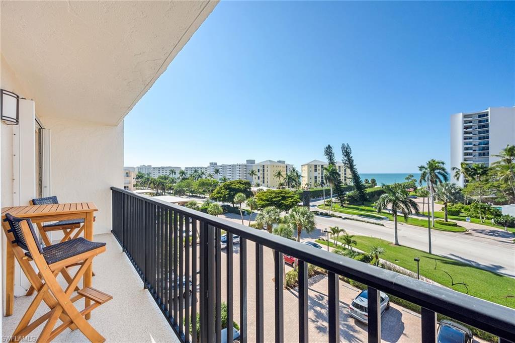 3500 Gulf Shore Boulevard North, Unit 505 Naples, FL 34103 - Photo 1 of 28 a city view from a balcony with outdoor space