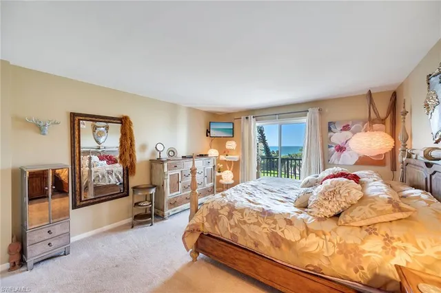 a bedroom with a bed and dresser with mirror