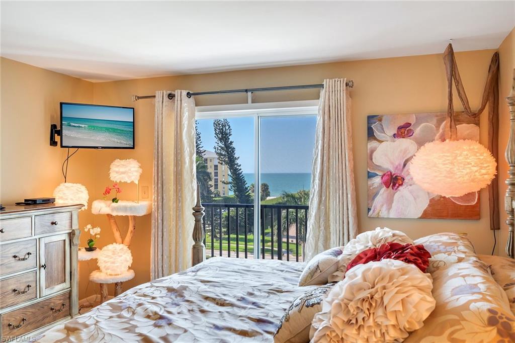 3500 Gulf Shore Boulevard North, Unit 505 Naples, FL 34103 - Photo 14 of 28 a bedroom with a bed and a window
