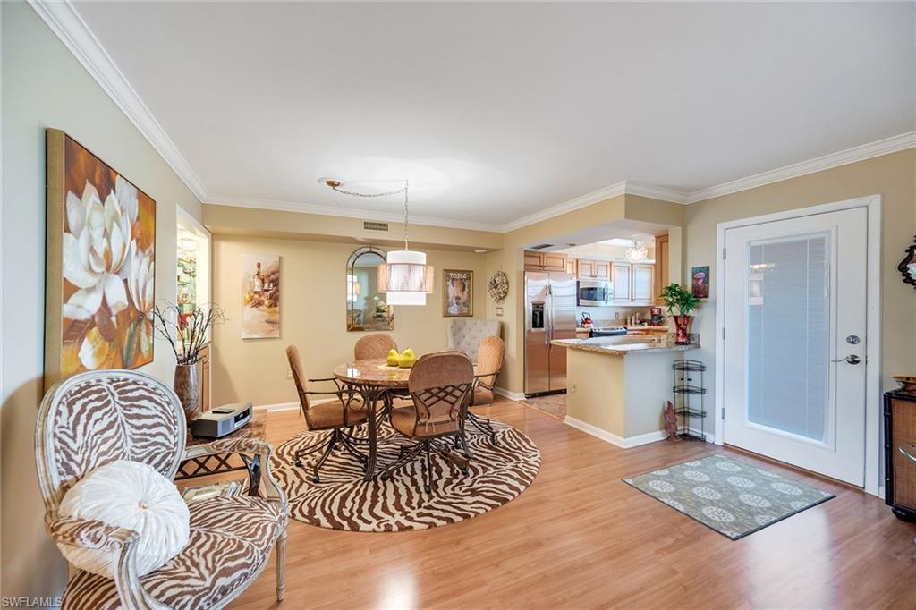 3500 Gulf Shore Boulevard North, Unit 505 Naples, FL 34103 - Photo 4 of 28 a living room with furniture and wooden floor