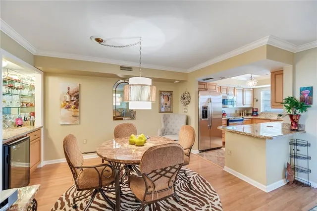 a view of a dining room with furniture and chandelier