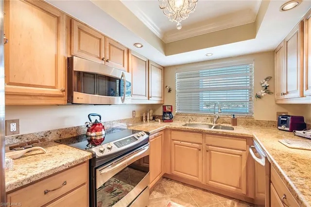 a kitchen with stainless steel appliances granite countertop a sink stove microwave and cabinets