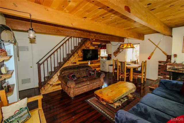 a view of a livingroom with furniture wooden floor and front door