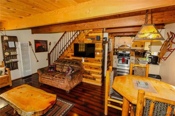 a view of a living room with furniture and wooden floor