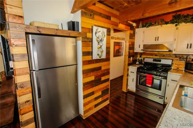a kitchen with stainless steel appliances a refrigerator and a stove top oven