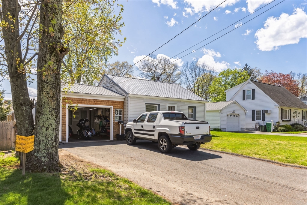 394 James Street Chicopee, MA 01020 - Photo 3 of 15 a front view of a house with a yard and garage