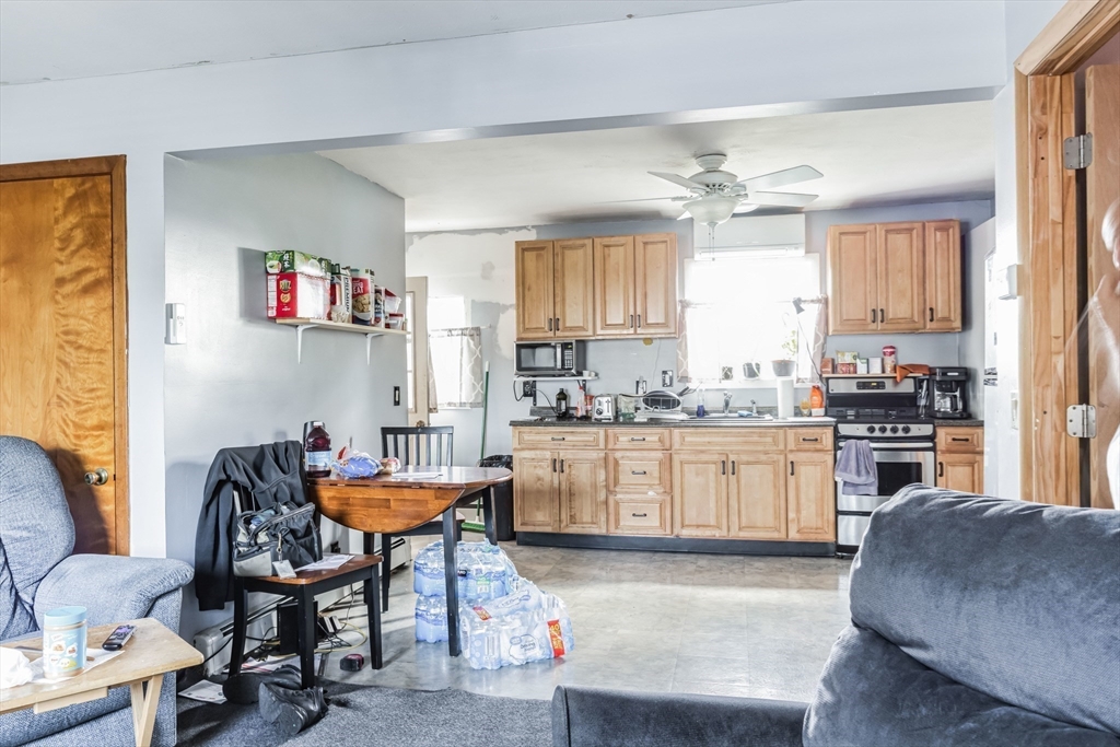 394 James Street Chicopee, MA 01020 - Photo 4 of 15 a kitchen with cabinets a sink and a stove top oven with wooden floor