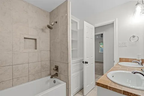 a bathroom with a tub and a sink