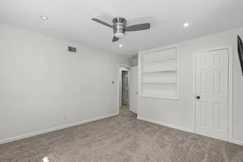 an empty room with closet and entryway