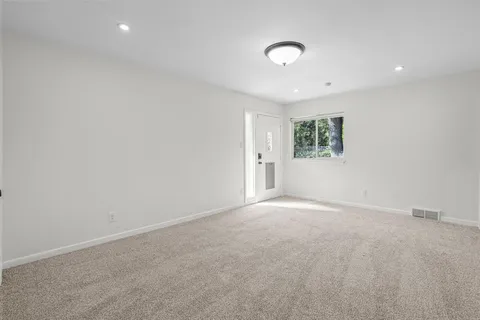 an empty room with windows and closet