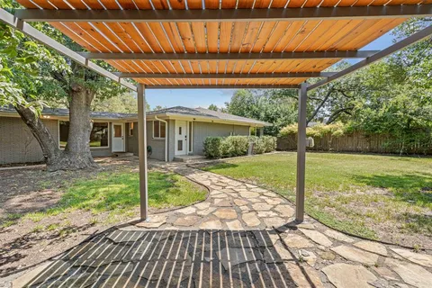 a view of a house with backyard porch and sitting area