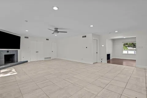 a view of an empty room with a fireplace