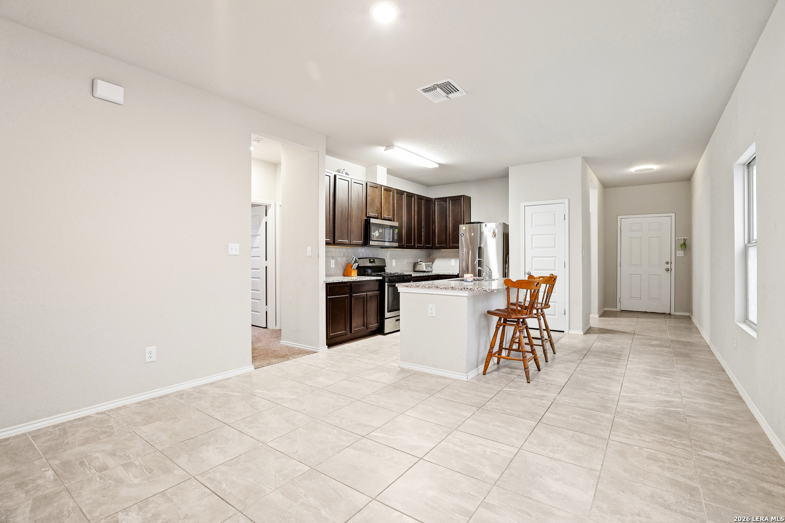 5314 Riley Way St. Hedwig, TX 78152 - Photo 14 of 26 a kitchen with a chandelier and a refrigerator
