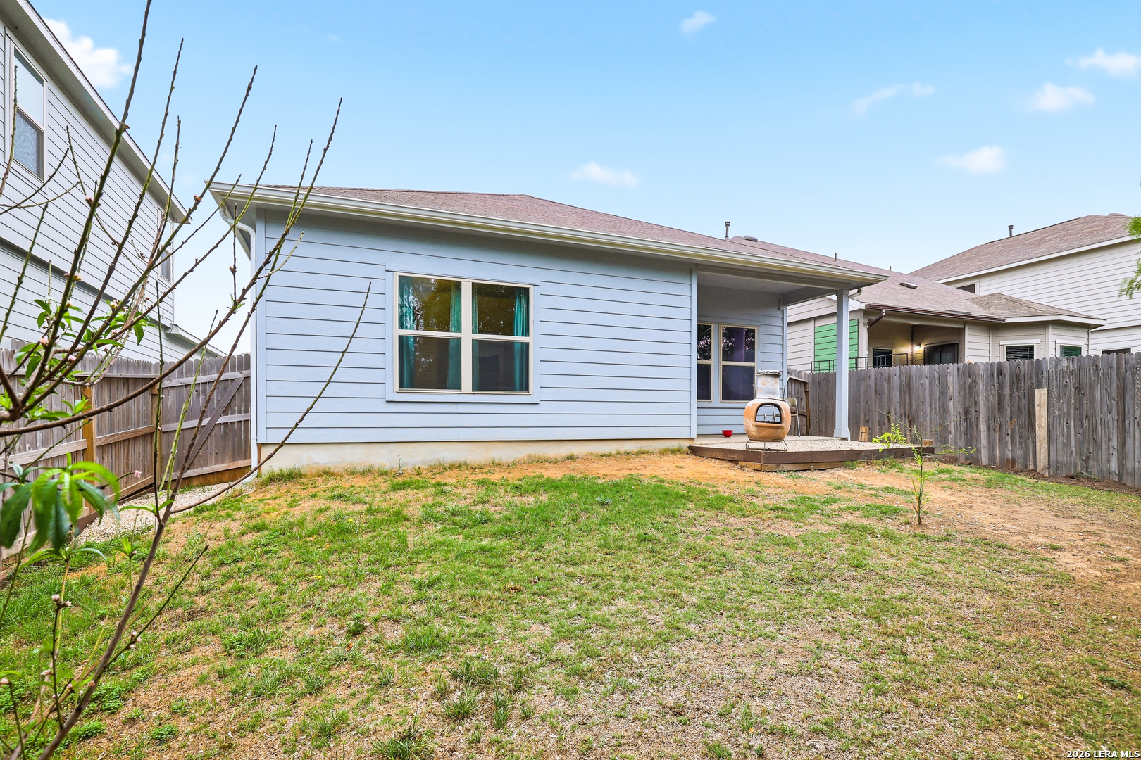 5314 Riley Way St. Hedwig, TX 78152 - Photo 25 of 26 a backyard of a house with table and chairs under an umbrella