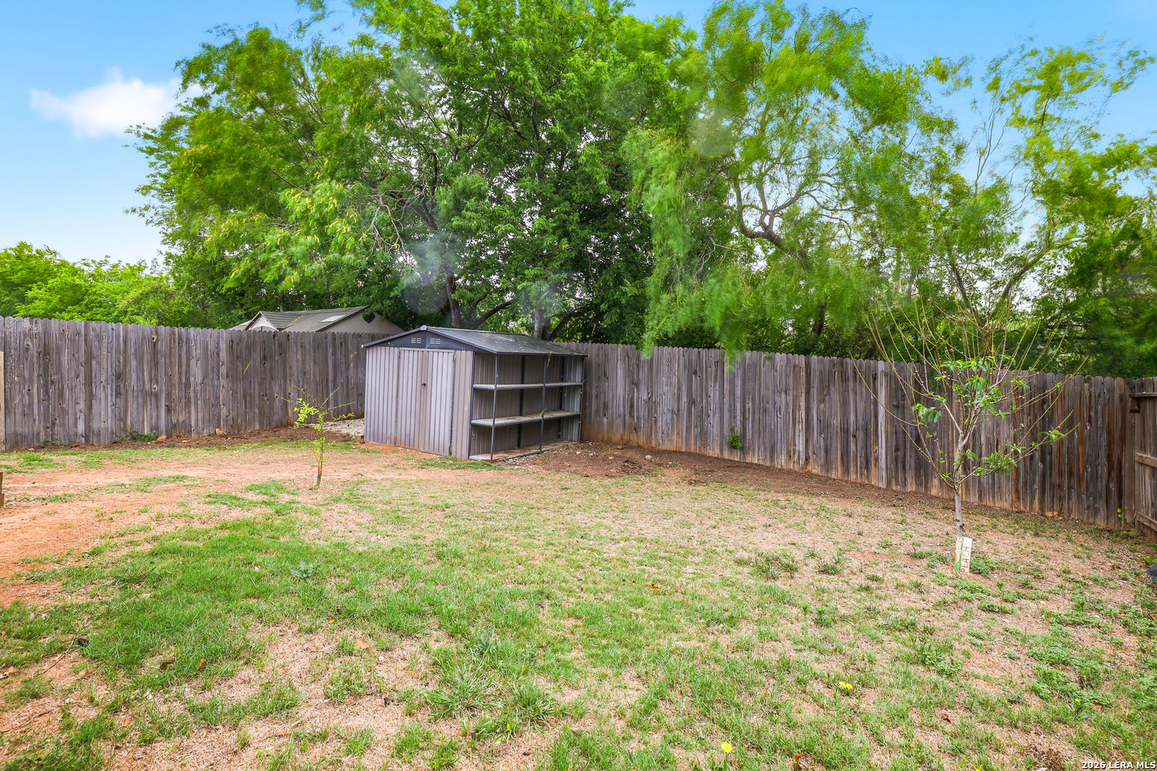 5314 Riley Way St. Hedwig, TX 78152 - Photo 26 of 26 a view of a backyard with large trees and wooden fence